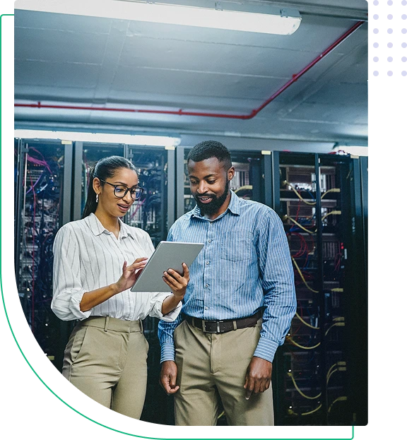 Two people discussing in a server room.